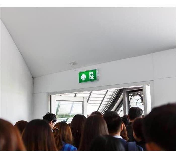 People escaping through an exit door